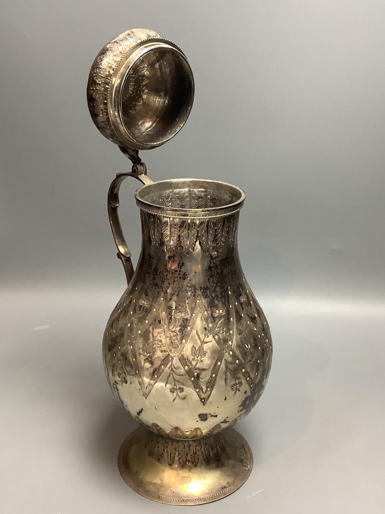 A Persian engraved white metal baluster flagon